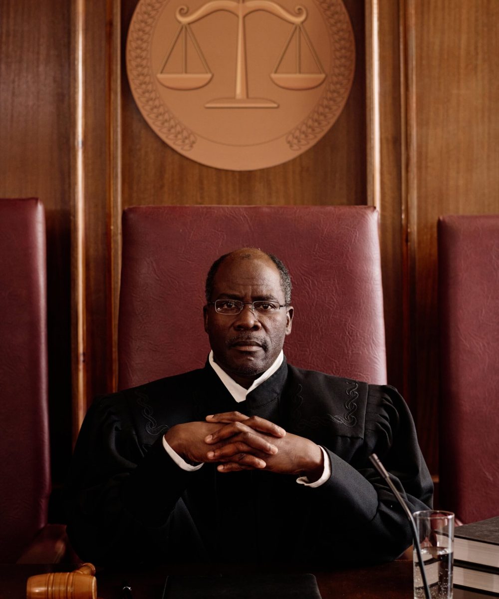 serious-mature-african-american-male-judge-eyeglasses-black-mantle-looking-camera-min